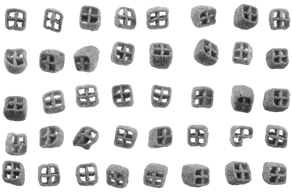 Black and white picture of individual Bissli (a crunchy wheat snack) arranged artfully in a grid pattern.